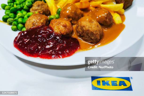 Ikea classic meal with Swedish meatballs, French fries, green peas and lingonberry sauce is served in Ikea restaurant in a store in Krakow in Krakow,...