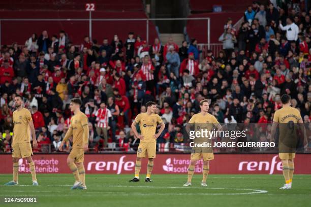 Barcelona's players react during the Spanish League football match between UD Almeria and FC Barcelona at the Municipal Stadium of the Mediterranean...
