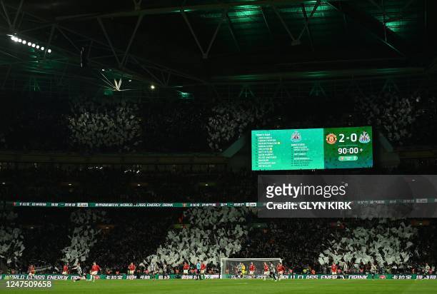 Giant display shows the 2-0 scoreline to Manchester United at the 90th minute, as injury time is played during the English League Cup final football...