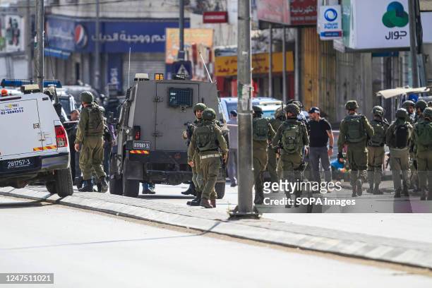 Israeli soldiers and paramedics inspect the scene of the shooting attack on two Jewish settlers near Hawara, south of Nablus in the occupied West...