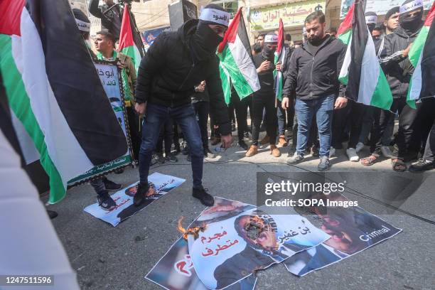 Masked Palestinian man burns the pictures of the Israeli National Security Minister Itamar Ben-Gvir during the demonstration against an...