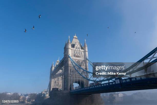 Thick fog clears over the capital at Tower Bridge making a peaceful yet eerie atmosphere as structures appear and disappear over the River Thames on...