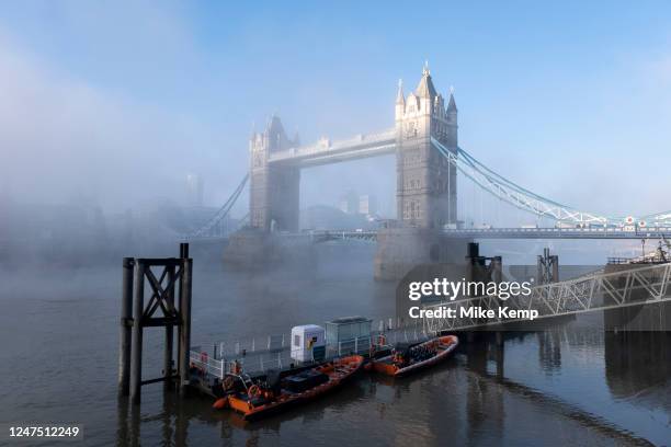 Thick fog starts to clear over the capital at Tower Bridge making a peaceful yet eerie atmosphere as structures appear and disappear over the River...