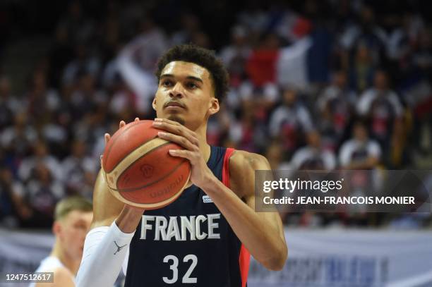 France's power forward Victor Wembanyama holds the ball during the qualifying match for the 2023 World Cup between France and Lithuania, in Trelaze,...