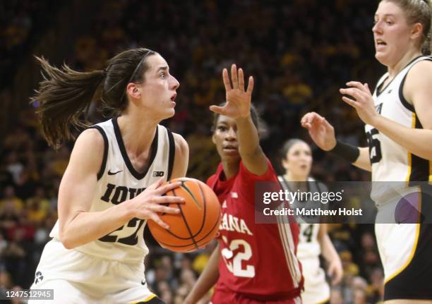 Guard Caitlin Clark of the Iowa Hawkeyes goes to the basket against guard Chloe Moore-McNeil of the Indiana Hoosiers during the first half of the...