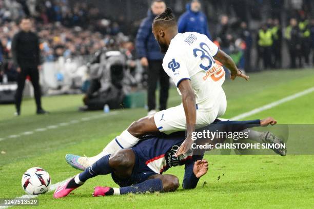 Paris Saint-Germain's Portuguese defender Nuno Mendes and Marseille's Portuguese defender Nuno Tavares fall during the French L1 football match...