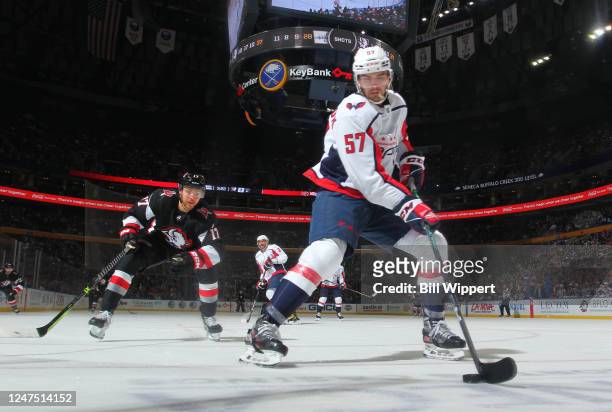 Trevor van Riemsdyk of the Washington Capitals controls the puck against Tyson Jost of the Buffalo Sabres during an NHL game on February 26, 2023 at...