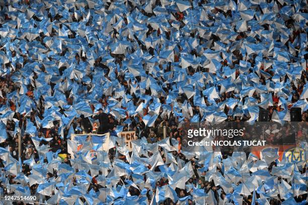Marseille's supporters wave flags during the French L1 football match between Olympique Marseille and Paris Saint-Germain at the Velodrome stadium in...