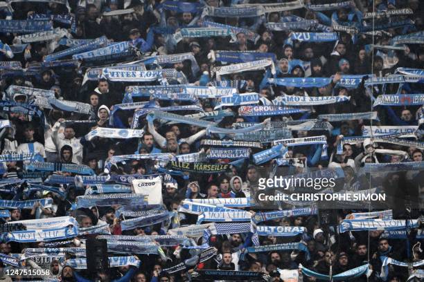 Marseille's supporters wave scarfs during the French L1 football match between Olympique Marseille and Paris Saint-Germain at the Velodrome stadium...