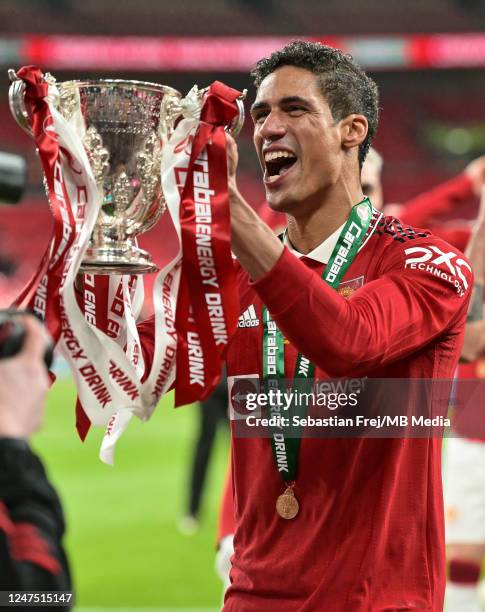 Raphael Varane of Manchester United celebrates with the trophy after winning the Carabao Cup Final match between Manchester United and Newcastle...