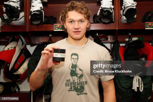 Kirill Kaprizov of the Minnesota Wild holds up three pucks after scoring a hat trick during the game against the Columbus Blue Jackets at the Xcel...