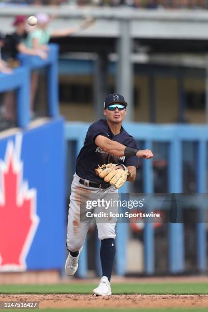 New York Yankees infielder Anthony Volpe throws the ball over to first base during the spring training game between the New York Yankees and the...