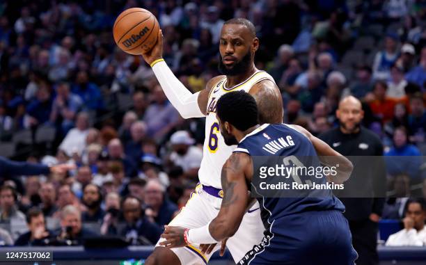 LeBron James of the Los Angeles Lakers handles the ball as Kyrie Irving of the Dallas Mavericks defends in the second half at American Airlines...