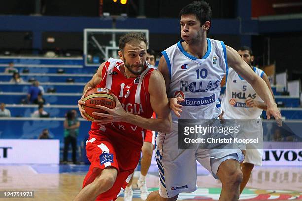 Konstantinos Papanikolaou of Greece defends against Viktor Sanikidze of Georgia during the EuroBasket 2011 second round group F match between Greece...