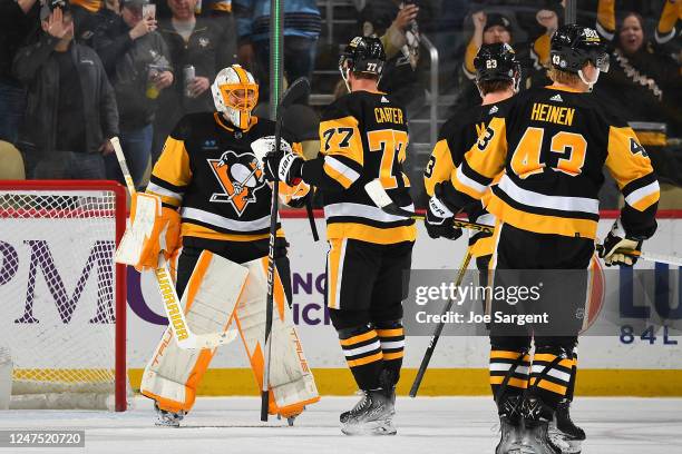 Casey DeSmith of the Pittsburgh Penguins celebrates with Jeff Carter after a 7-3 win over the Tampa Bay Lightning at PPG PAINTS Arena on February 26,...