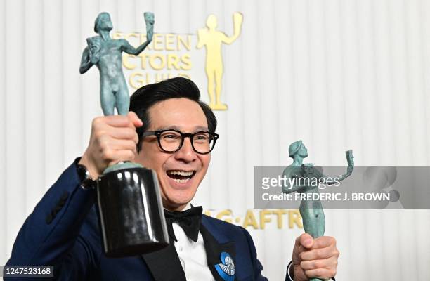 Vietnamese actor Ke Huy Quan poses with the awards for outstanding Male Actor in a Supporting Role - Motion Picture and Outstanding Performance by a...