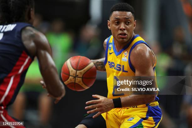 Brazil's Yago dos Santos controls the ball during the FIBA Basketball World Cup 2023 Americas qualifiers match between Brazil and USA at the Arnão...