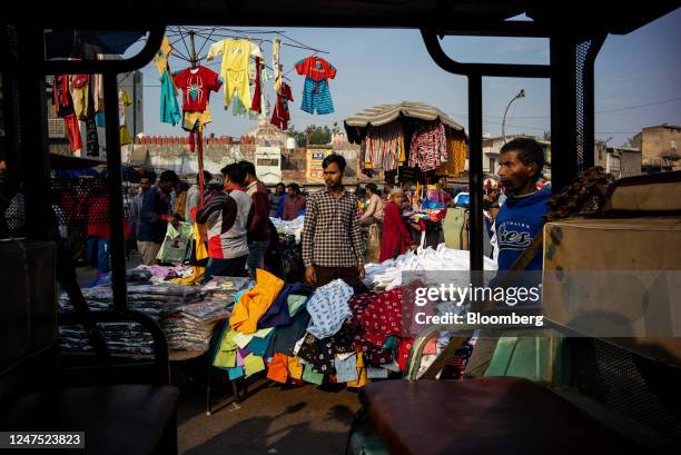 Shopkeeper waits for customers at a market in New Delhi, India, on Sunday, Feb. 26, 2023. Indias GDP growth likely slowed to 4.6% year on year in...