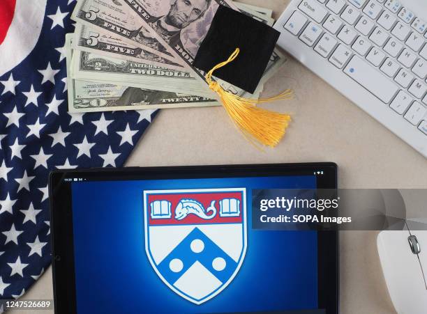 In this photo illustration, University of Pennsylvania logo seen displayed on a tablet.