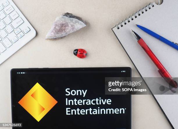 In this photo illustration, a Sony Interactive Entertainment logo seen displayed on a tablet.