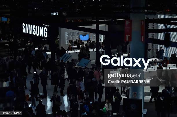 Visitors walk beneath a Samsung logo at the Mobile World Congress , the telecom industry's biggest annual gathering, in Barcelona on February 27,...