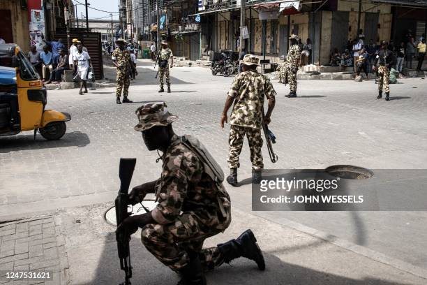 Soldiers from the Nigerian Armed Forces take position and secure the streets in Lagos Island, Lagos, on February 27 after hoodlums had harassed...