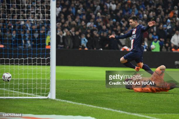 Paris Saint-Germain's Argentine forward Lionel Messi shoots to score past Marseille's Spanish goalkeeper Pau Lopez during the French L1 football...