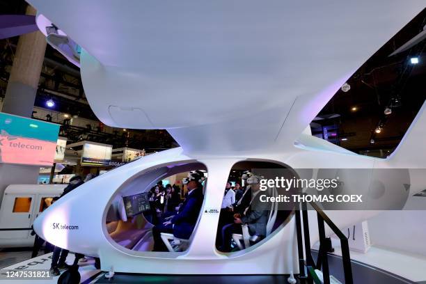 Visitors attend a demonstration of the urban UAM aircraft taxi by South Korean company SK Telecom at the Mobile World Congress , the telecom...