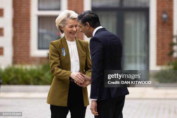 Britain's Prime Minister Rishi Sunak greets European Commission chief Ursula von der Leyen as she arrives at the Fairmont Hotel in Windsor, west of...