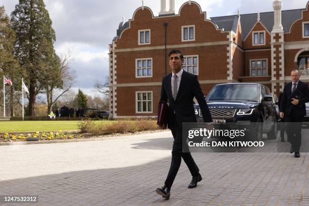 Britain's Prime Minister Rishi Sunak and Britain's Northern Ireland Secretary Chris Heaton-Harris arrive at the Fairmont Hotel in Windsor, west of...