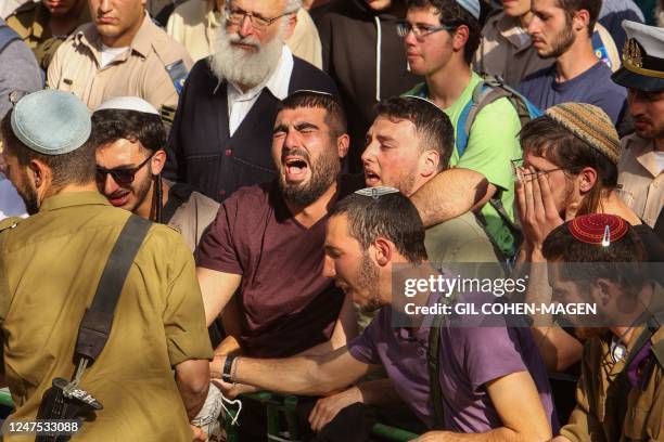 Mourners react during the funeral of Israeli settlers, brothers Yagel Yaniv and Hallel Yaniv at the military cemetery in Jerusalem on February 27 a...