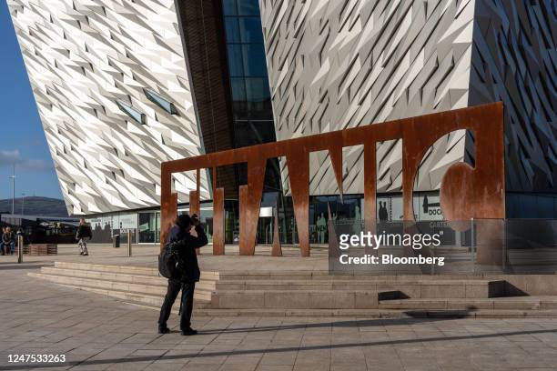 Visitor takes a photographer outside the Titanic Belfast visitor attraction in the Titanic Quarter in Belfast, Northern Ireland, on Friday, Feb. 24,...
