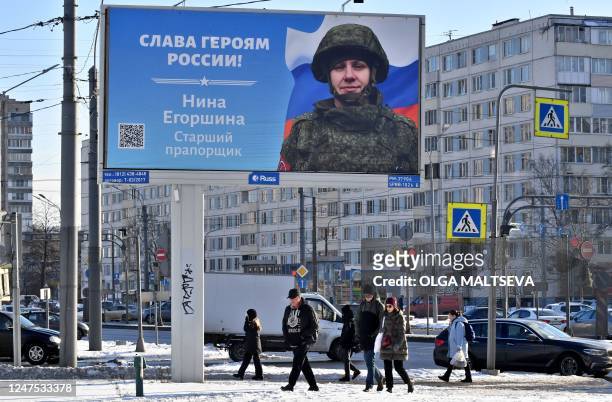 Billboard with an image of a Russian servicewoman and the slogan reading "Glory to the Heroes of Russia!" decorates a street in Saint Petersburg on...