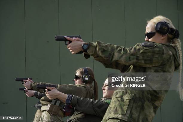 Trainees of the inaugural female bodyguards training course practice shooting at the Russian University of Special Forces in the town of Gudermes in...