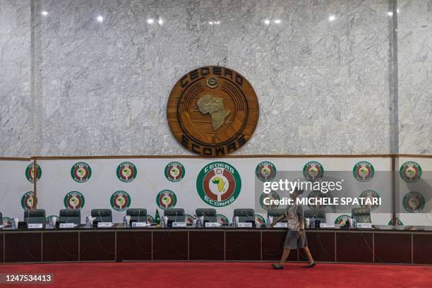 An ECOWAS staff member walks past a stage before a press conference organized by the Commonwealth, The Economic Community of West African States and...