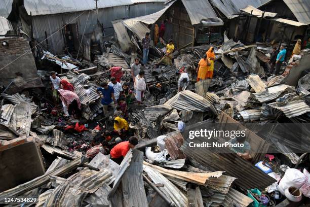 Slum dwellers search for their household belonging after a fire broke out at the Korail Slum area that burnt around 50-60 houses in the capital...