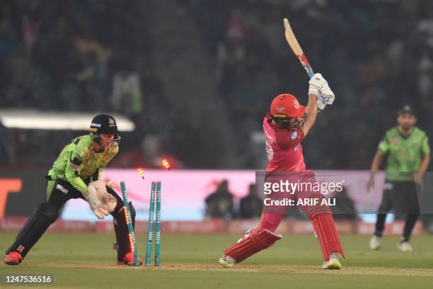 Islamabad United's Tom Curran is clean bowled by Lahore Qalandars' Rashid Khan during the Pakistan Super League T20 cricket match between Lahore...