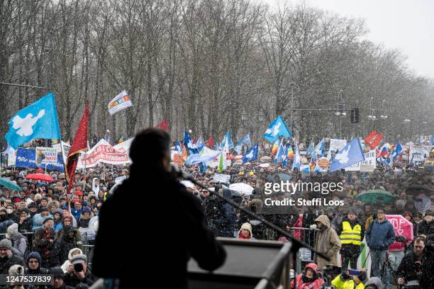 Crowds listen as Sahra Wagenknecht, member of the left wing party Die Linke gives a speech in front the Brandenburg Gate during a protest for peace...