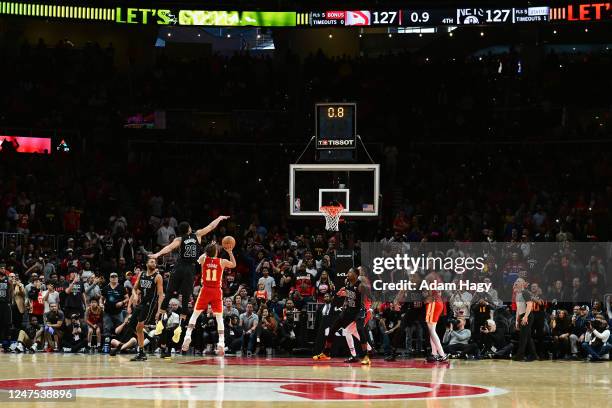 Trae Young of the Atlanta Hawks makes the game winning shot against the Brooklyn Nets on February 26, 2023 at State Farm Arena in Atlanta, Georgia....