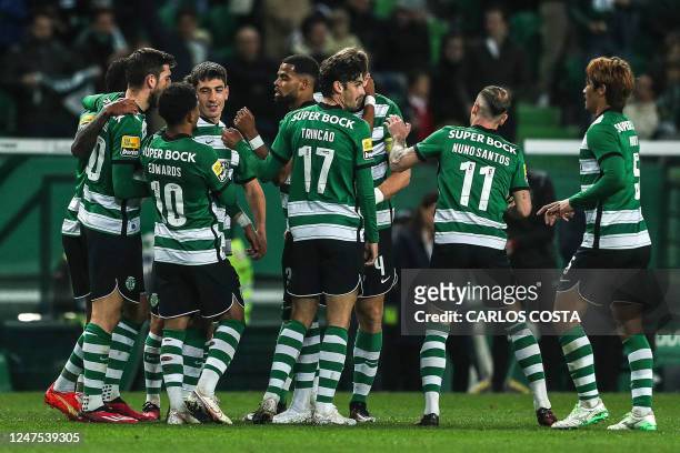 Sporting's players celebrate the opening goal scored by Spanish defender Hector Bellerin during the Portuguese league football match between Sporting...