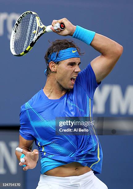 Rafael Nadal of Spain hits a return against Novak Djokovic of Serbia during the Men's Final on Day Fifteen of the 2011 US Open at the USTA Billie...