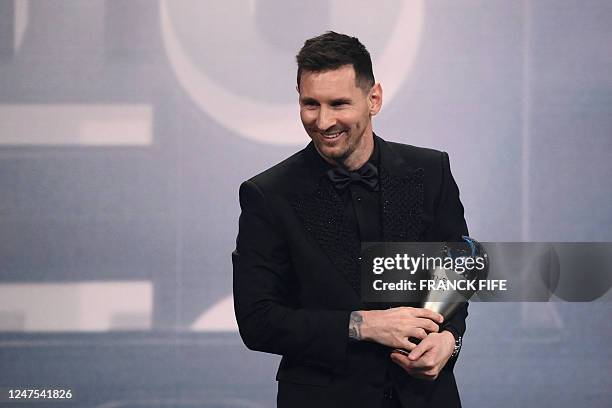 Argentina and Paris Saint-Germain forward Lionel Messi poses on stage after receiving the Best FIFA Men's Player award during the Best FIFA Football...
