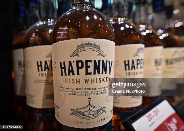 Selection of Ha'penny Irish Whiskey bottles on display in a Duty Free shop at Dublin Airport, in Dublin, Ireland, on February 17, 2023. According to...