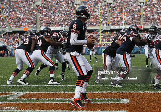 Jay Cutler of the Chicago Bears looks for a receiver as teammates J'Marcus Webb, Chris Williams, Roberto Garza and Chris Spencer block against the...