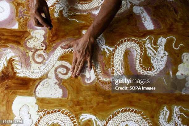 Craftsman makes a hand-drawn batik for a wall decoration at the Batik Seno Gallery, Yogyakarta. Decorative batiks sell for anything between 150,000...