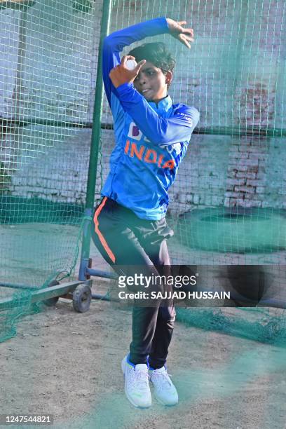 In this photograph taken on February 20 Indian cricketer Sonam Yadav bowls during a net practice at a ground in Firozabad in Uttar Pradesh state. -...