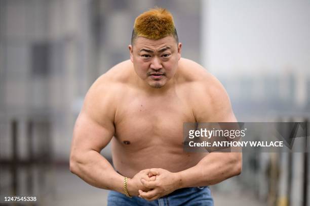In this photo taken on February 18 Korean car dealer Jo Jin-hyeong, a contestant from the new Netflix show Physical: 100, poses during an interview...
