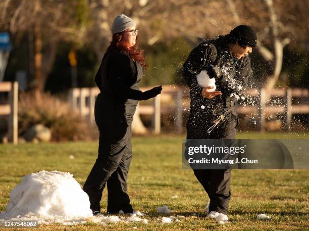 Carmen Meza lands a shot during a snowball fight with boyfriend James Rodriguez with what remains of the snow at Acton Park on Monday, Feb. 27, 2023....