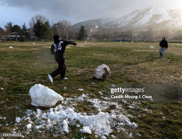 James Rodriguez and Miguel Manzo have a snowball fight with what remains of the snow at Acton Park on Monday, Feb. 27, 2023. The weather forecast...