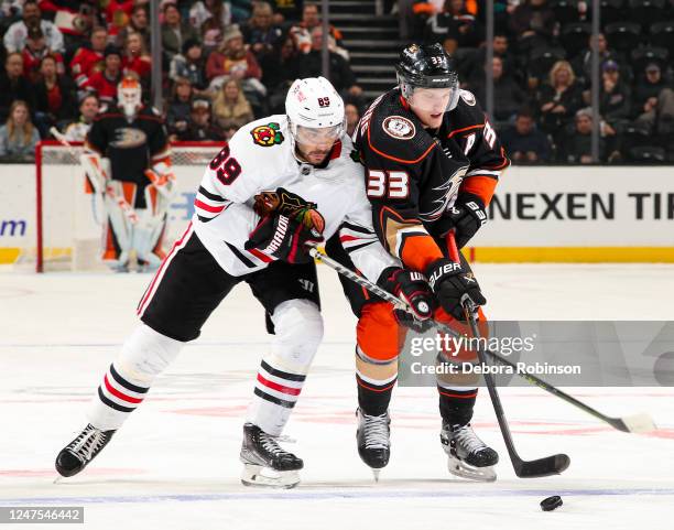 Andreas Athanasiou of the Chicago Blackhawks and Jakob Silfverberg of the Anaheim Ducks battle for the puck during the first period at Honda Center...